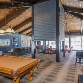 Spacious clubhouse and media lounge with pool table and games.