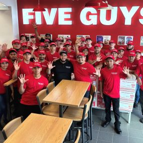 Employees pose for a photograph in the dining room ahead of the grand opening of the Five Guys at 1028 Marble Terrace Street in Hoover, Alabama.