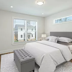 The bedroom at Belle Meadow Homes offers a bright and comfortable space for rest and relaxation.