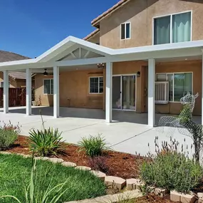 White custom aluminum patio cover with gabled roof line and lighting in Hemet, CA