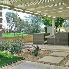 Double beam Alumawood trellis cover over a Beautiful backyard patio area.