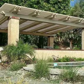 Large Alumawood pergola cover installed over existing stucco columns.