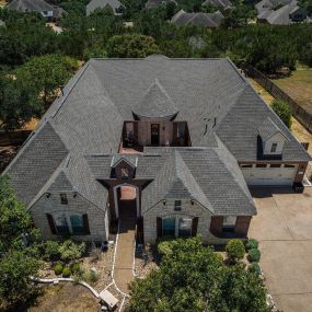 A home with a new shingle roof in San Antonio, TX provided by ARP Roofing