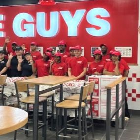 Employees pose for a photograph ahead of the grand opening of the Five Guys restaurant at 35109 S. Gratiot Avenue in Clinton Township, Michigan.