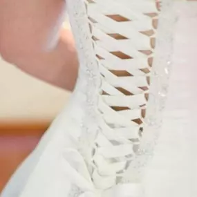 Expertly crafted corset back on a stunning wedding dress. Let us enhance your dream gown with impeccable alterations.