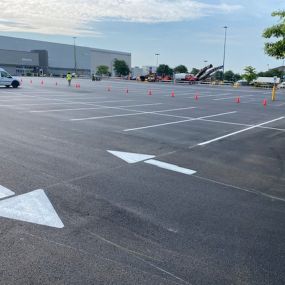 Parking lot displaying directional arrows use to guide traffic.