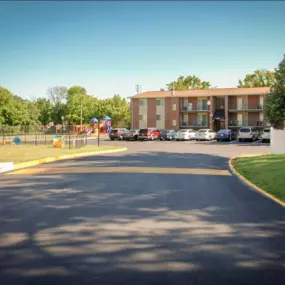 Freshly paved road featuring a speed bump installed an apartment complex.