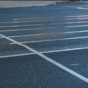 Chamberlain Contractors employee measuring the out the parking lines