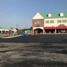 Chamberlain Contractors employees working together at a job site outside of s strip mall