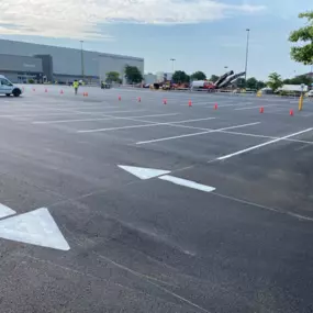 Parking lot displaying directional arrows use to guide traffic.