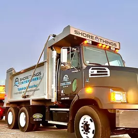 Shore Things Environmental truck with excavator-blue sky in background