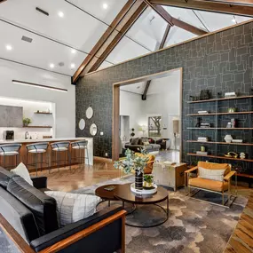 A modern living room with a black couch and a wooden coffee table