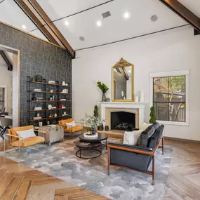 A living room with a fireplace and a mirror on the wall