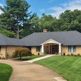Moire Black LandMark Pro shingle's with tuxedo gray gutters proved to be two handsome additions to this home