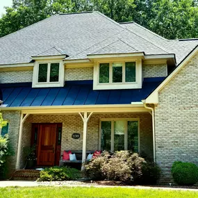 Full roof replacement with Charcoal Black LandmarkPro shingles,  new black standing seam metal roof and new cream 6