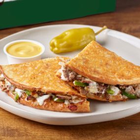 Parmesan crusted flatbread-style sandwich with Philly sauce, cheese, steak, onions and green peppers. Served with garlic dipping sauce.