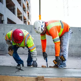 Pro-Pave Inc. Contractors Repairing a Concrete Curb