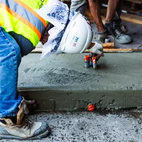 Pro-Pave Inc. Contractor Smoothing Concrete With a Float