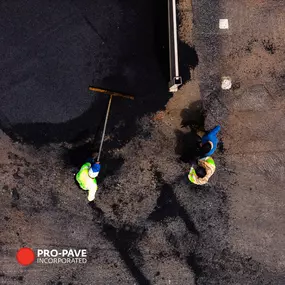 Pro-Pave Inc. Contractors Laying a New Layer of Asphalt