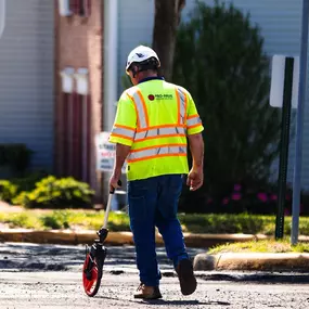 Pro-Pave Inc. Contractor Using a Measuring Wheel