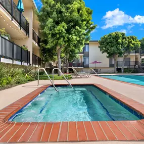 a resort style pool is next to an apartment building