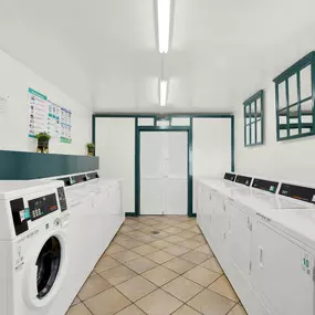a washer and dryer in a laundry room with washing machines