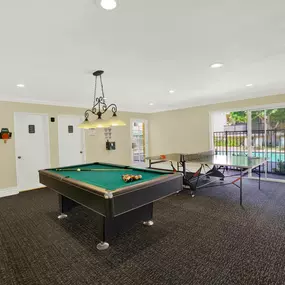 a game room with a pool table and a ping pong table