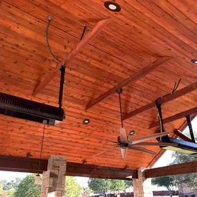 Custom outdoor living space including new commercial gas heaters, custom lighting, and sound/media constructed by Trent Massey Construction