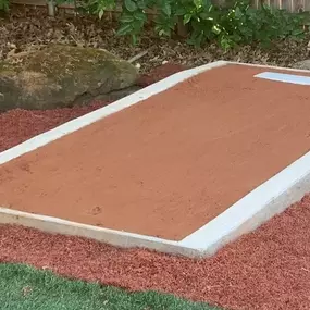 Our Cages and Courts service builds residential pitching mound with concrete curb, regulation rubber, and high school red clay