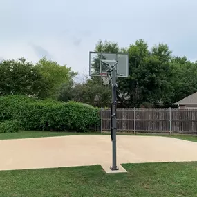 Custom shaped basketball court constructed by our Cages and Courts services