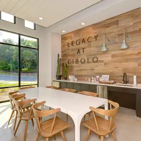 a dining room with a white table and chairs