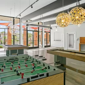 The community game room at Sentry Tempe Apartments features foosball and billiards for resident entertainment.
