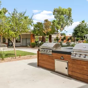 A picnic area at Sentry Tempe Apartments equipped with BBQ stations for outdoor dining and social gatherings.