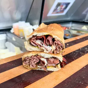 NY style black pastrami with melted swiss on a submarine sandwich