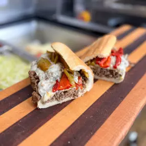 Steak, melted provolone, and roasted red peppers on a submarine sandwich