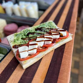 A limited time offering of fresh pesto, balsamic glaze, fresh mozarella, and seasoned tomatoes