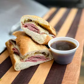 Our French Dip is served with top round roast beef, melted swiss, horseradish dijon aioli & au jus for dipping