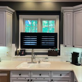 We love the look of these black cafe shutters we installed in a local Wake Forest home! These stylish window treatments provide privacy while allowing natural light to brighten your space. Perfect for kitchens and dining areas!