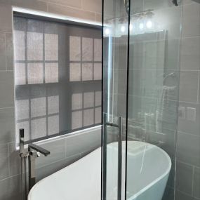 We love the look of these locally installed roller shades! The gray shade style matches the aesthetic of this chic bathroom perfectly. Our motorized roller shades also allow effortless remote control of your Budget Blinds roller shades and integrate seamlessly with your favorite smart home devices!