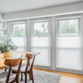 Cellular shades, also known as honeycomb shades, are a modern and energy-efficient window treatment that will complement your dining space wonderfully. They feature a unique cellular structure that creates pockets of air, which provides excellent insulation against the heat and cold!