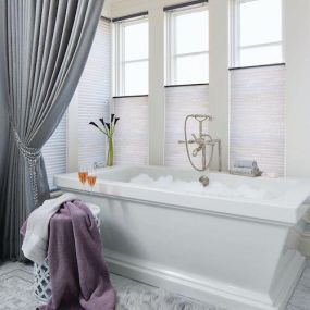 We LOVE how these cellular shades complement this chic bathroom. Their unique honeycomb design provides superior insulation, keeping your home cozy in the winter and cool in the summer. Plus, their cordless operation ensures safety and a sleek, clutter-free look.