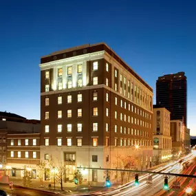 The One Atlantic Apartments glow with modern elegance in a nighttime street view in Stamford, CT.