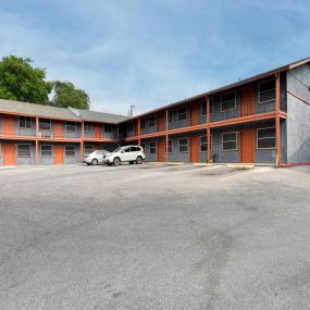 a motel with a parking lot in front of a building