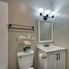 a small bathroom with a toilet and a sink and a mirror