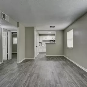 an empty living room and kitchen in a new home