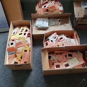 Boxes of old computer punch cards for shredding