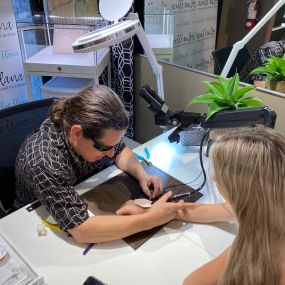 Permanent Jewelry being done on a girls wrist at the Elisa Ilana Jewelry Store