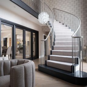 Curved staircase with chrome balustrade