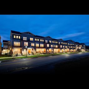 Exterior street view of The Lofts at Saratoga Blvd 3-story apartment buildings.