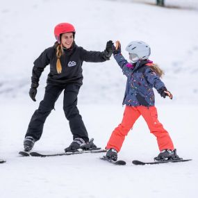 High fives and good times learning the skiing basics.